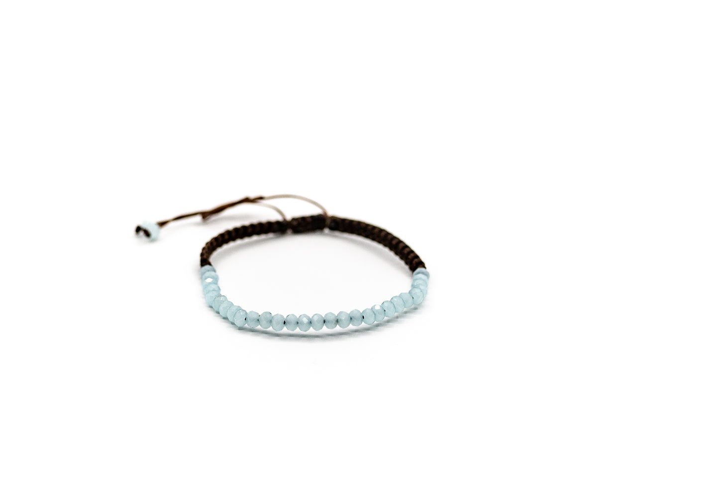 PALM STRINGS - SMALL LIGHT TURQUOISE CRYSTAL BEADS ON BROWN STRING