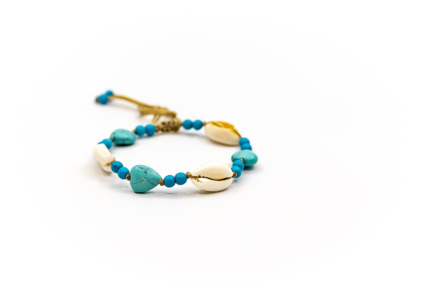 PALM STRINGS - COWRIES AND HEARTS WITH SMALL BLUE BEADS ON SAND STRING