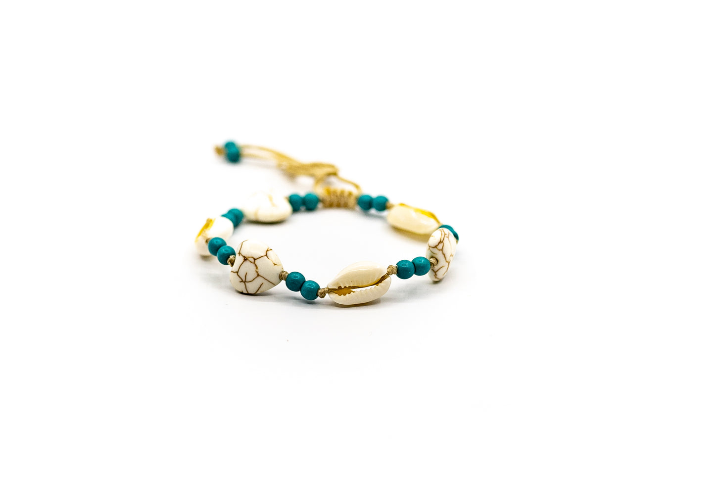 PALM STRINGS - COWRIES AND HEARTS WITH SMALL DARK TURQUOISE BEADS ON SAND STRING