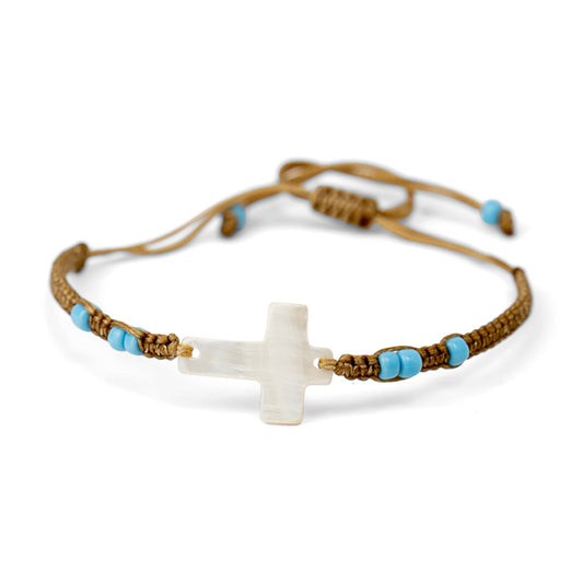 PALM STRINGS - SMALL WHITE MOTHER OF PEARL CROSS WITH SMALL BLUE BEADS ON SAND STRING
